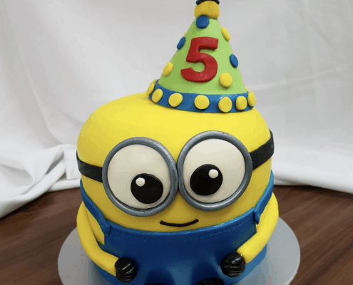 Detská torta v tvare oslavujúceho mimoňa s párty čiapkou